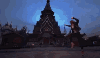 a woman is jumping in the air in front of a very tall building