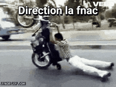 a man is laying on the ground while riding a motorcycle with direction la fnac written on the bottom