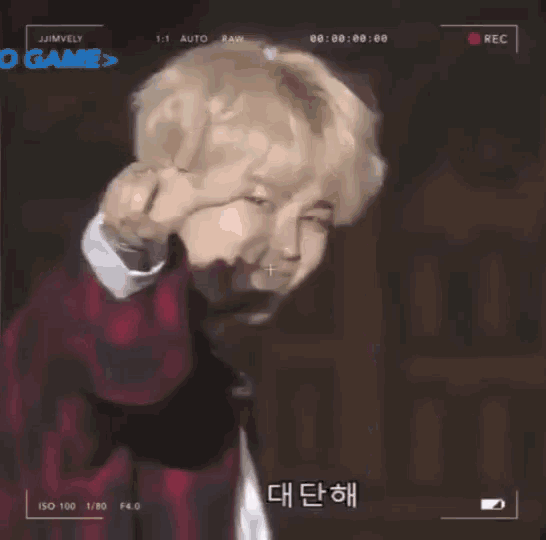 a man is making a funny face in front of a camera that says ' o game > ' on it