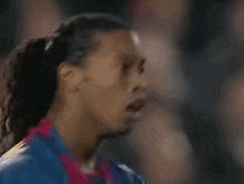a close up of a man 's face with his mouth open .