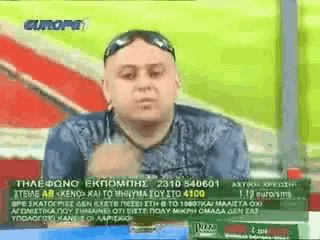 a man is sitting in front of a green screen with the word europe on it