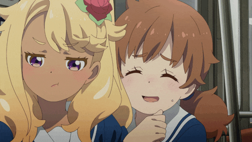 a girl with a flower in her hair is smiling next to another girl with a flower in her hair