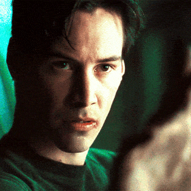 a close up of a man 's face with a green shirt