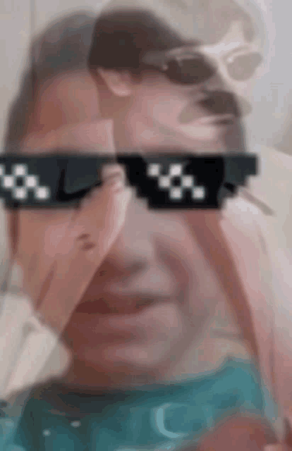a blurry picture of a man wearing sunglasses and a mustache .