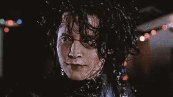 a close up of a person 's face with wet hair
