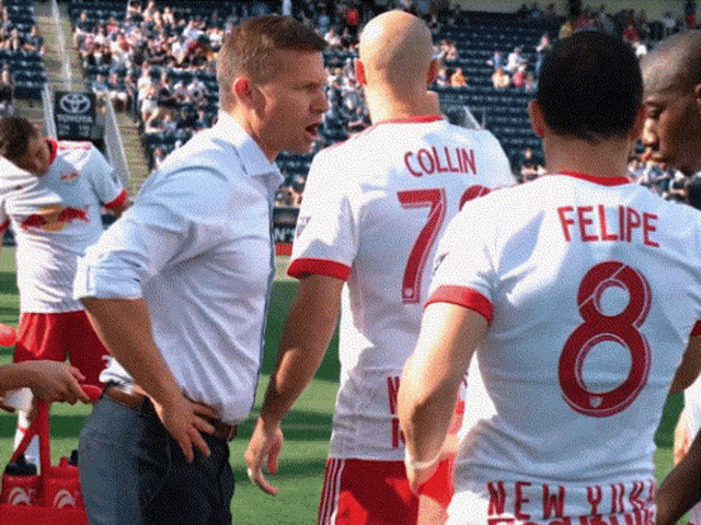soccer players collin and felipe are talking to each other on the field