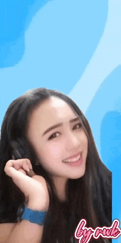 a woman wearing headphones and a blue watch with the words by rude on the bottom right