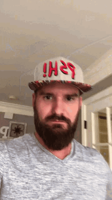 a man with a beard wearing a hat that says hi on it