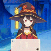 a girl in a witch hat is using a laptop