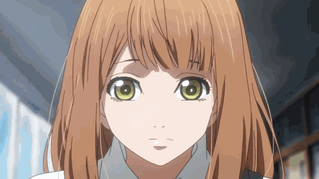 a close up of a girl 's face with a serious look on her face