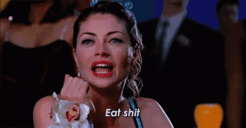 a woman in a prom dress is crying and holding a flower in her hand .