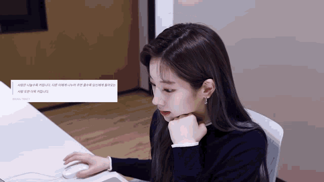 a woman sits at a desk with her hand on her chin and a message that says brain track on it