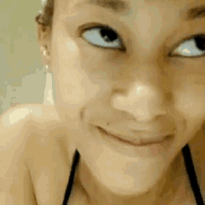 a close up of a woman 's face with a slight smile on her face