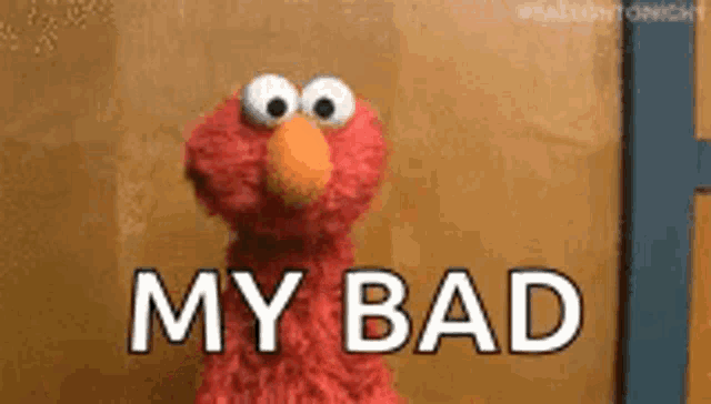 elmo from sesame street is standing in front of a wall with the words `` my bad '' written on it .