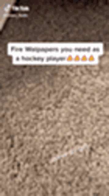 a blurred image of a carpeted floor with a white sticker on it