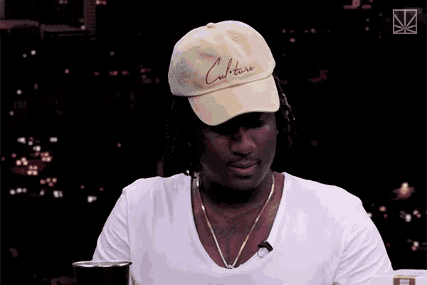 a man wearing a baseball cap says savage