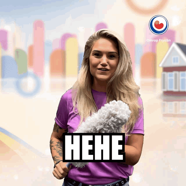 a woman in a purple shirt is holding a duster and has the word " hehe " on her chest