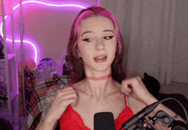 a woman with pink hair is wearing a choker