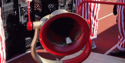 a red and gold object with a hole in the middle