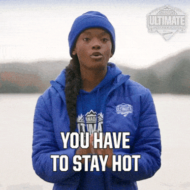 a woman wearing a blue jacket and a blue hat says " you have to stay hot "