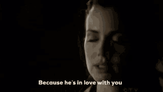 a close up of a man 's face with the words because he 's in love with you above him