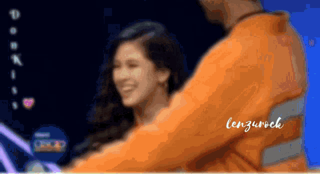a blurry picture of a man and a woman with the name lenzurock written on the bottom