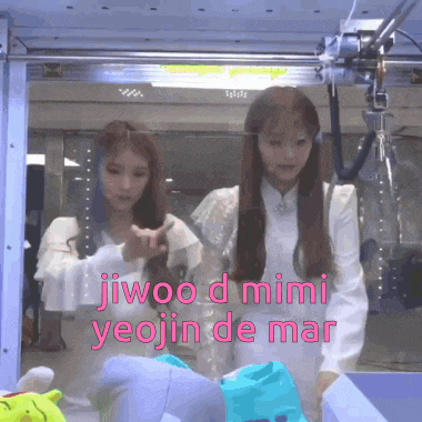 two women are standing in front of a machine with jiwoo d mimi yeojin de mar written above them