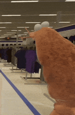 a cartoon character is standing in a store with clothes on display