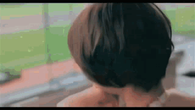 a close up of a woman 's back with short hair .