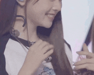 a close up of a woman wearing a headset and smiling .