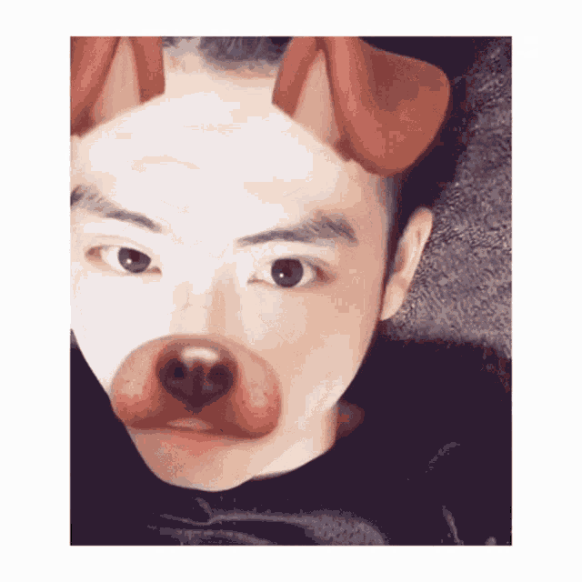 a young man wearing a dog mask on his face