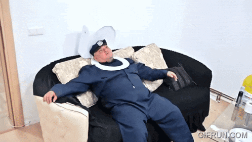 a man in a police uniform is laying on a couch with a gifrun.com watermark