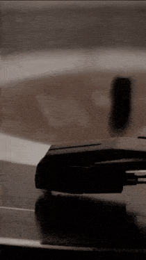 a close up of a record player playing a record on a table