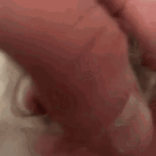 a close up of a person 's hand on a white surface with a red background .