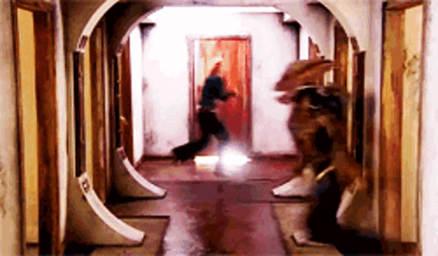 a blurred image of a hallway with a red door