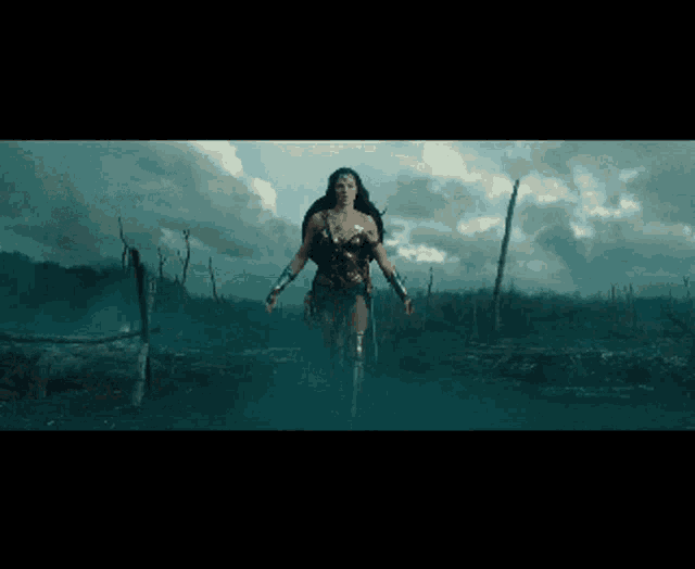 a woman in a wonder woman costume is standing in a field