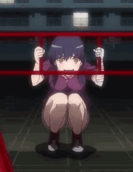 a girl is squatting down in a dark room behind a red railing