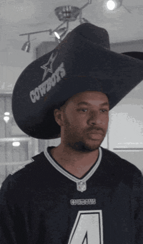a man wearing a cowboys jersey and a cowboys cowboy hat