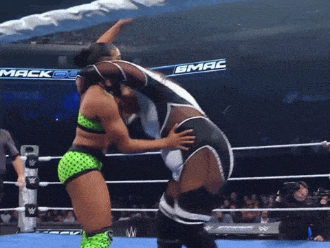 two women in a wrestling ring with a banner that says mack dc