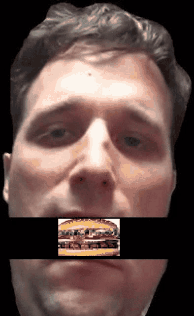 a close up of a man 's face with a picture of a hamburger behind his mouth