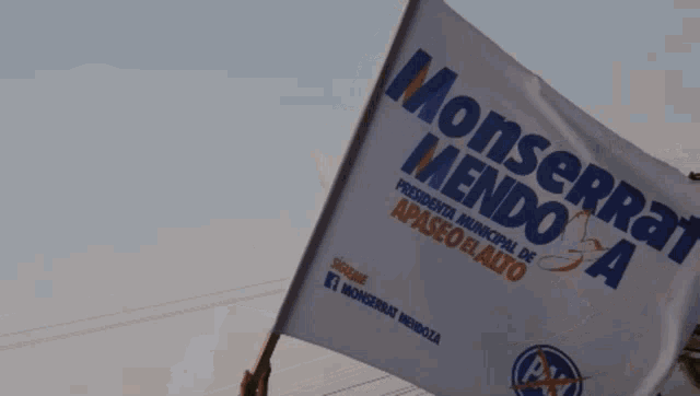 a person is holding a flag that says monserrat mendoza on it