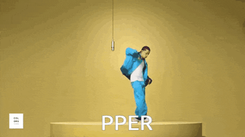 a man in a blue suit stands on a pedestal with the word pper written on the bottom