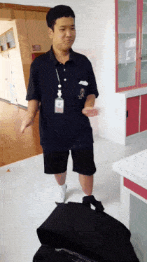 a man wearing a lanyard with a name tag that says ' a ' on it
