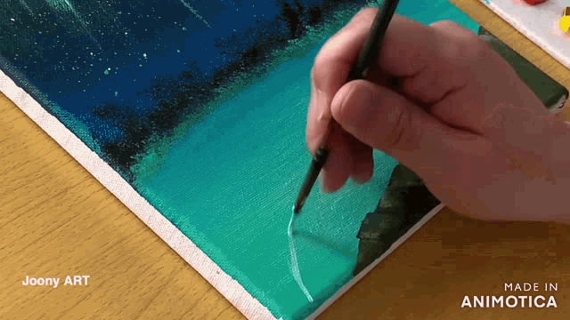 a person is painting on a canvas with the words made in animotica below them