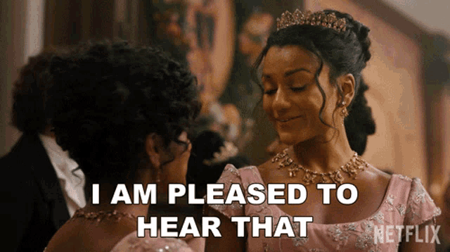 a woman in a pink dress says " i am pleased to hear that " while standing next to another woman