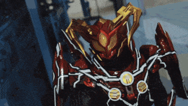 a close up of a red and gold robot with a shield on it