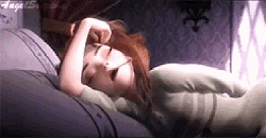 a woman is sleeping on a bed with her eyes closed and her mouth open .
