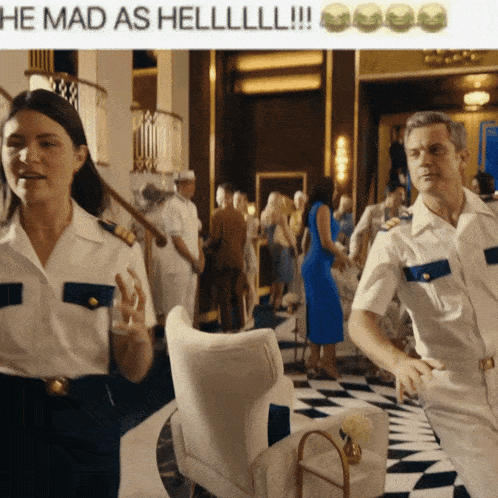 a man and a woman in military uniforms are standing in a hallway with the caption he mad as hell