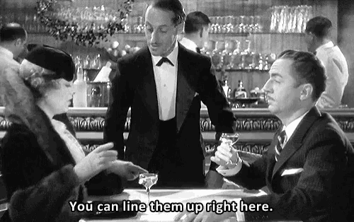a man in a tuxedo says " you can line them up right here " to a woman in a hat