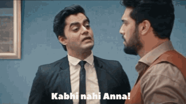 a man in a suit and tie is talking to another man with the words kabhi nahi anna written on the bottom